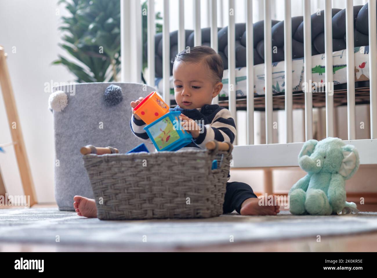 Curious baby boy sitting on bed hi-res stock photography and images - Alamy