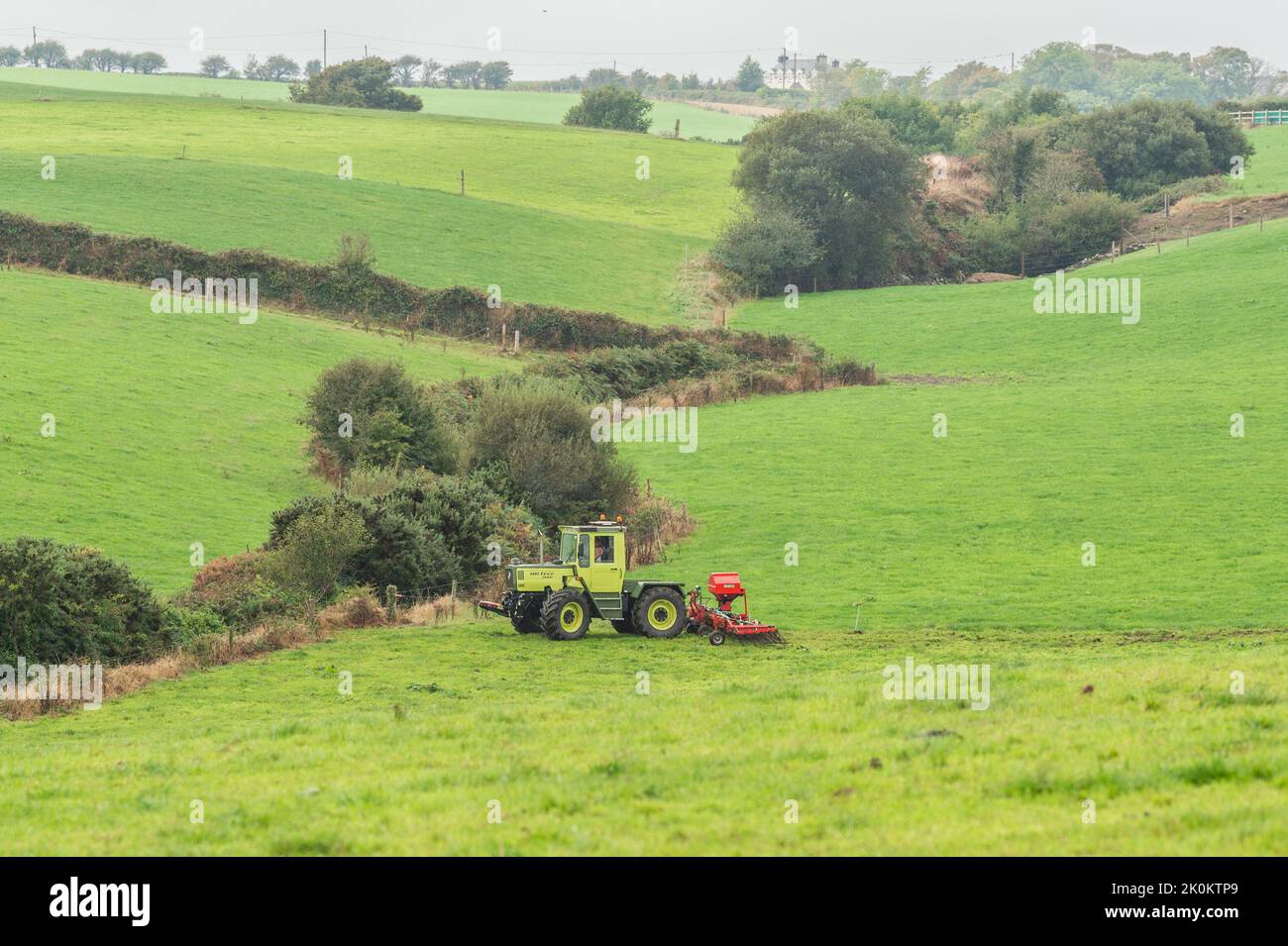 Timoleague, West Cork, Ireland. 12th Sep, 2022. A big exponent of sustainable farming, West Cork based dairy farmer David Deasy prepares the ground for stitching clover on his farm in Timoleague. David is using an Einbock Grass Harrow being hauled by a fully restored 1990 Mercedes MB Trac 1100 tractor. Credit: AG News/Alamy Live News Stock Photo