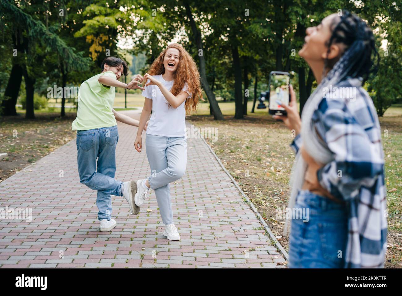 Group of teenagers blogger recording media content, filming video blog. Modern