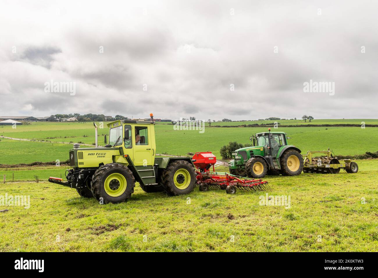 Timoleague, West Cork, Ireland. 12th Sep, 2022. A big exponent of sustainable farming, West Cork based dairy farmer David Deasy prepares the ground for stitching clover on his farm in Timoleague. David is using an Einbock Grass Harrow being hauled by a fully restored 1990 Mercedes MB Trac 1100 tractor followed by contractor Finbarr O'Donovan who is aerating the ground using an Alstrong Aerator. Credit: AG News/Alamy Live News Stock Photo