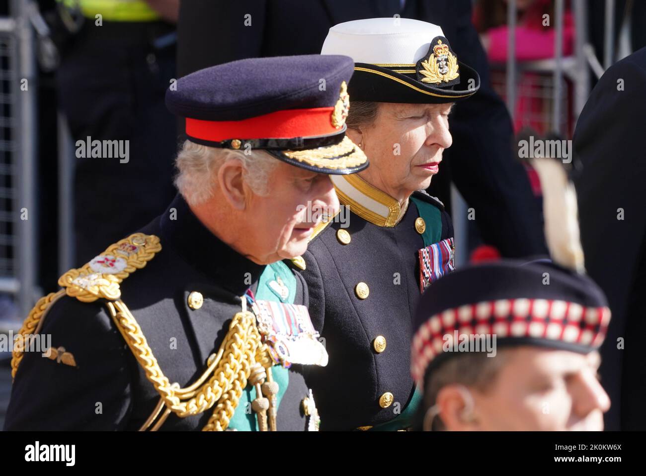 King Charles III and the Princess Royal walk behind Queen Elizabeth II
