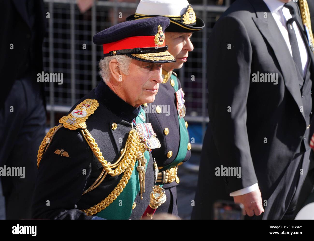 King Charles III and the Princess Royal walk behind Queen Elizabeth II