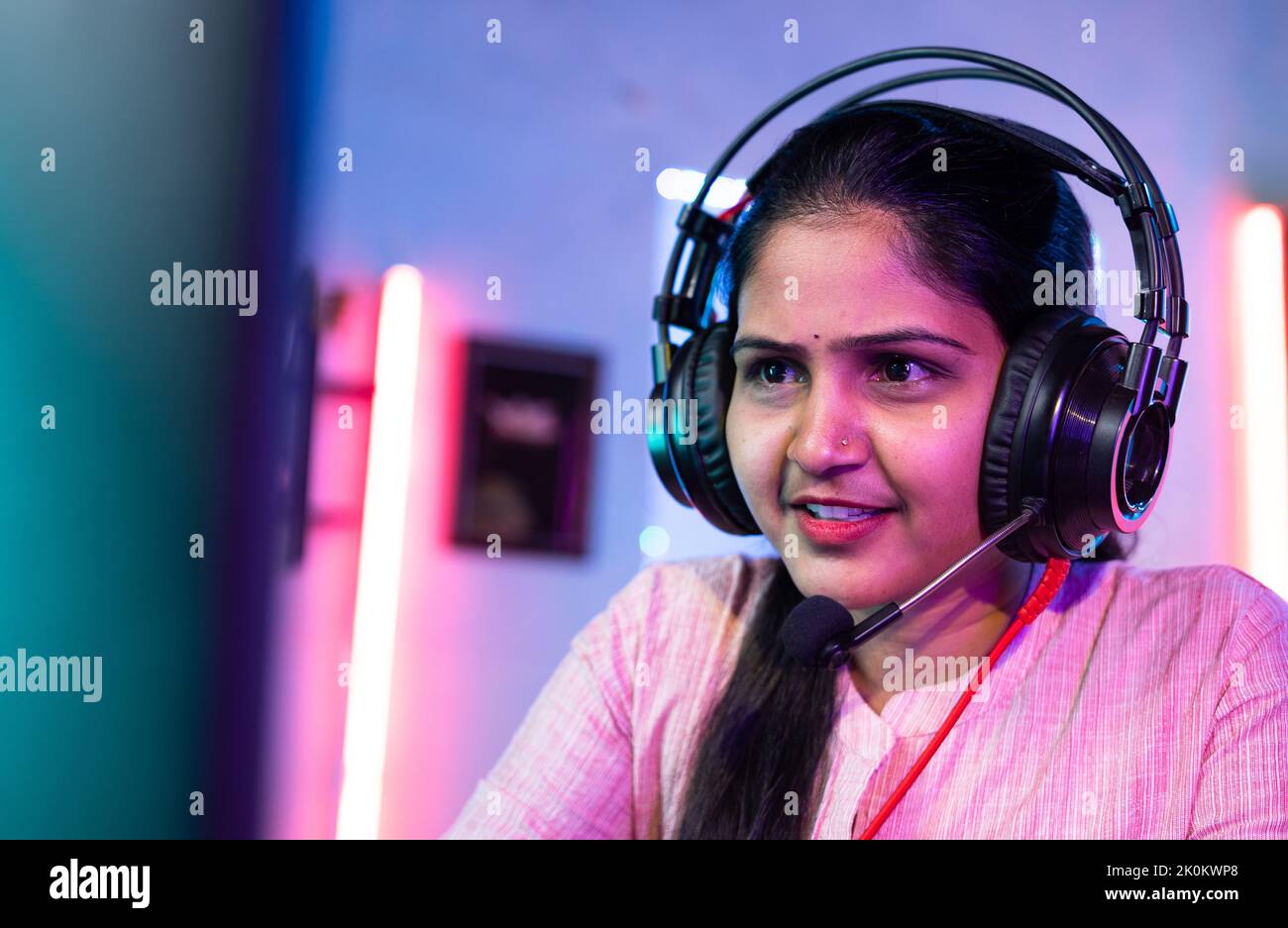 Close up shot of woman gamer live streaming video game by talking on headphones at home - concept of hobbyist, cyberspace and technology Stock Photo
