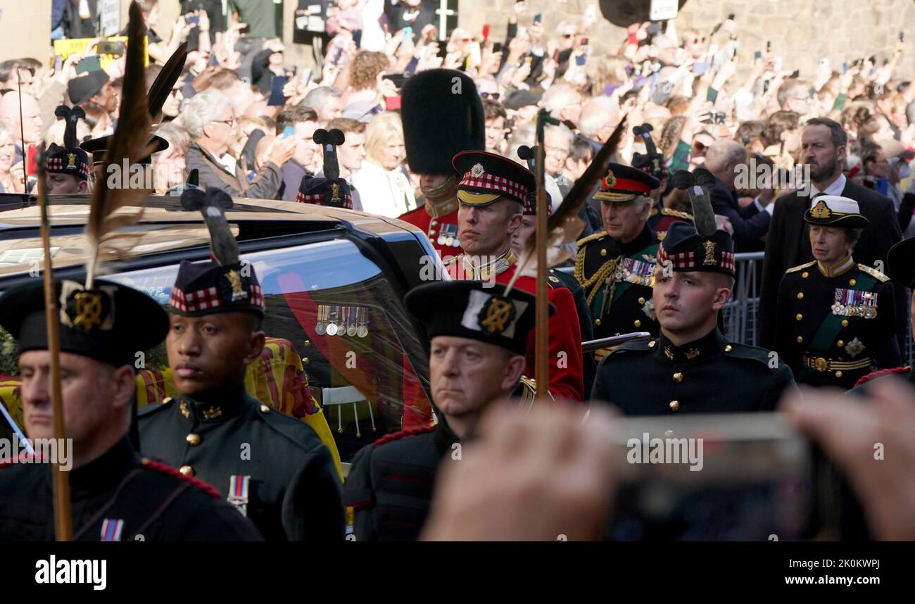 King Charles III and the Princess Royal walk behind Queen Elizabeth II