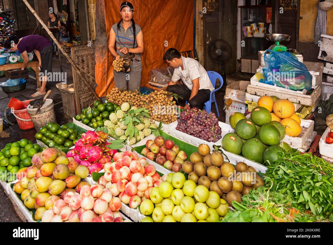 Vietnamese vendors, working in open air shop in street market, Hai Phong, Vietnam Stock Photo