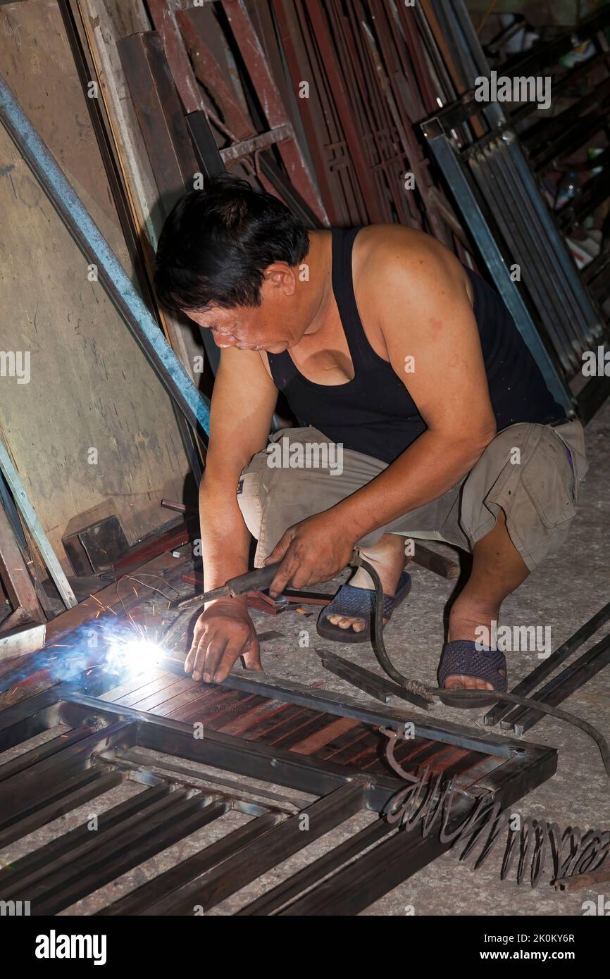 Vietnamese welder working in workshop, Hai Phong, Vietnam Stock Photo