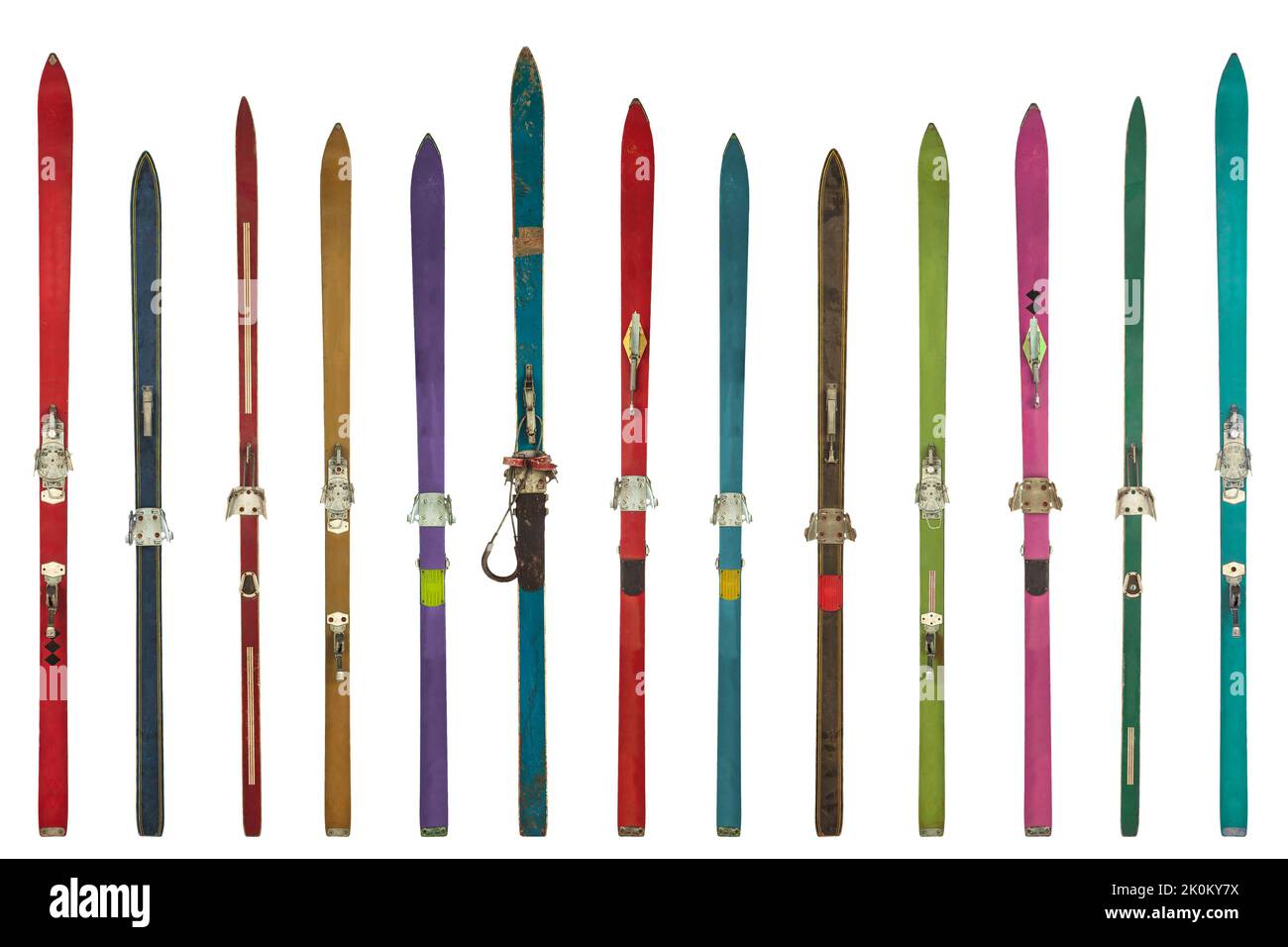 Row of vintage weathered colorful skis isolated on a white background Stock Photo