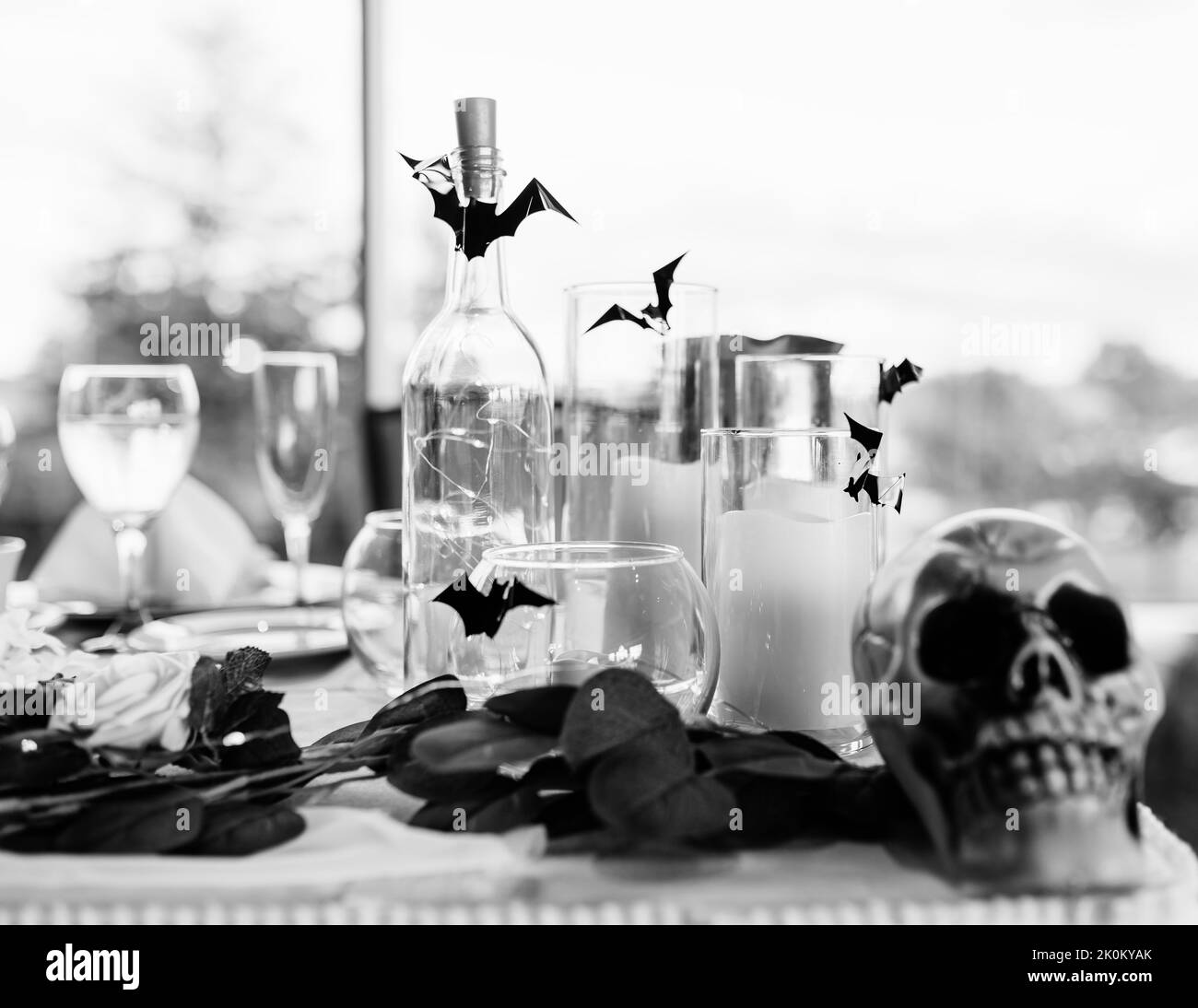 A beautiful grayscale shot of a wedding banquet table with Halloween themed decoration Stock Photo