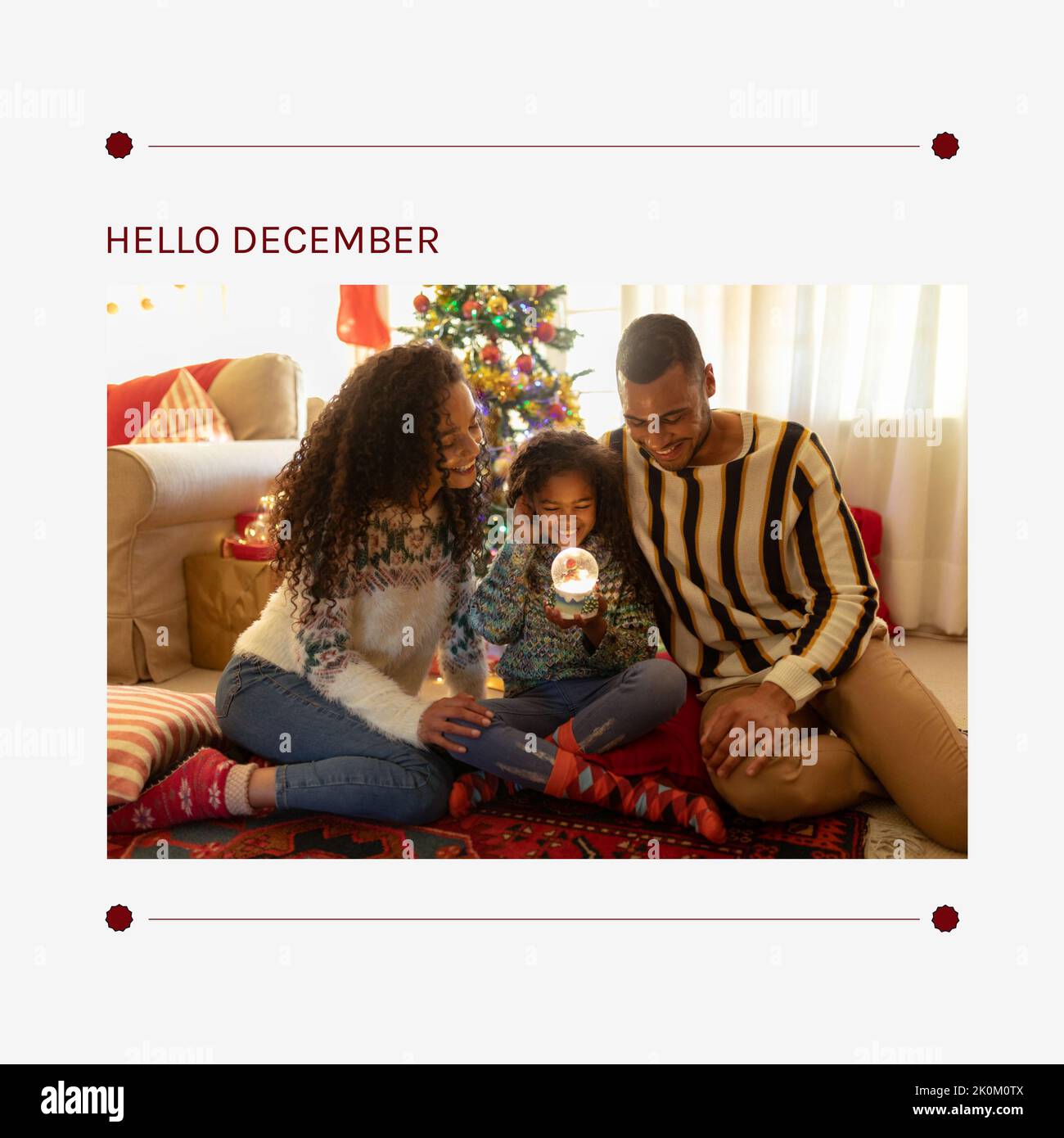 Composition of hello december text over african american family at christmas Stock Photo