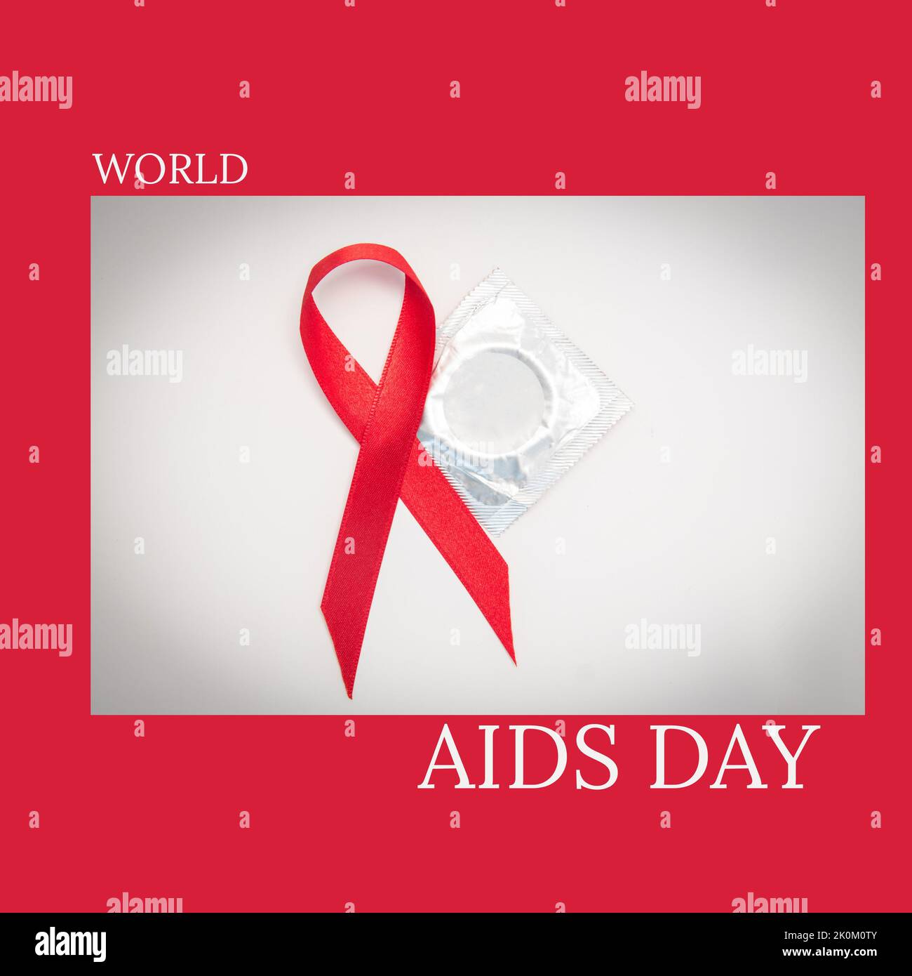 Composition of world aids day text over condom and aids ribbon Stock Photo