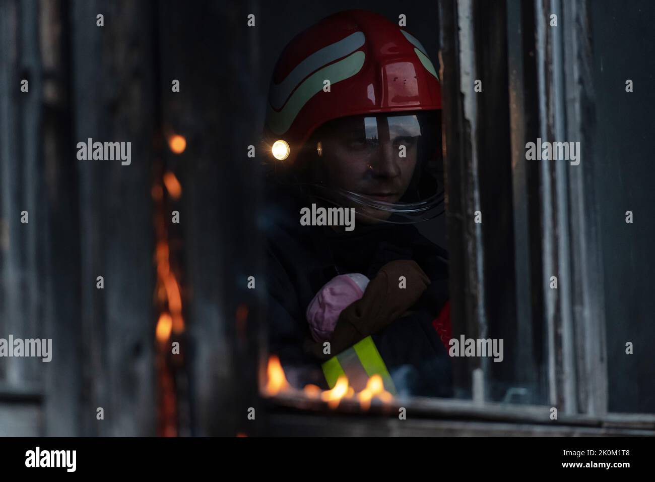 Firefighter hero carrying baby girl out from burning building area from ...