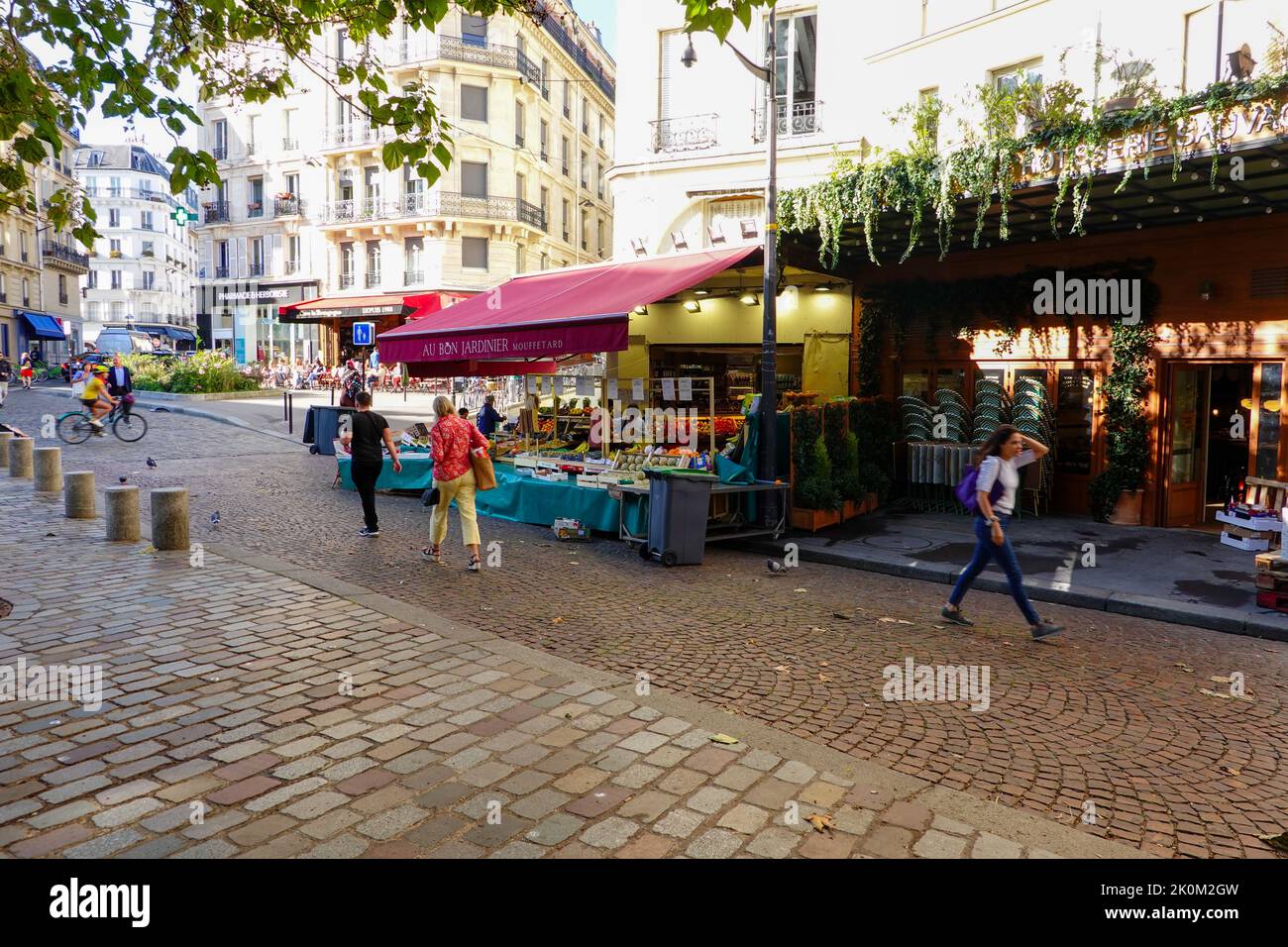 People walking past a fruit and vegetable shop off Pl. Georges Moustaki in the rue Mouffetard area, 5th Arrondissement, Paris, France. Stock Photo