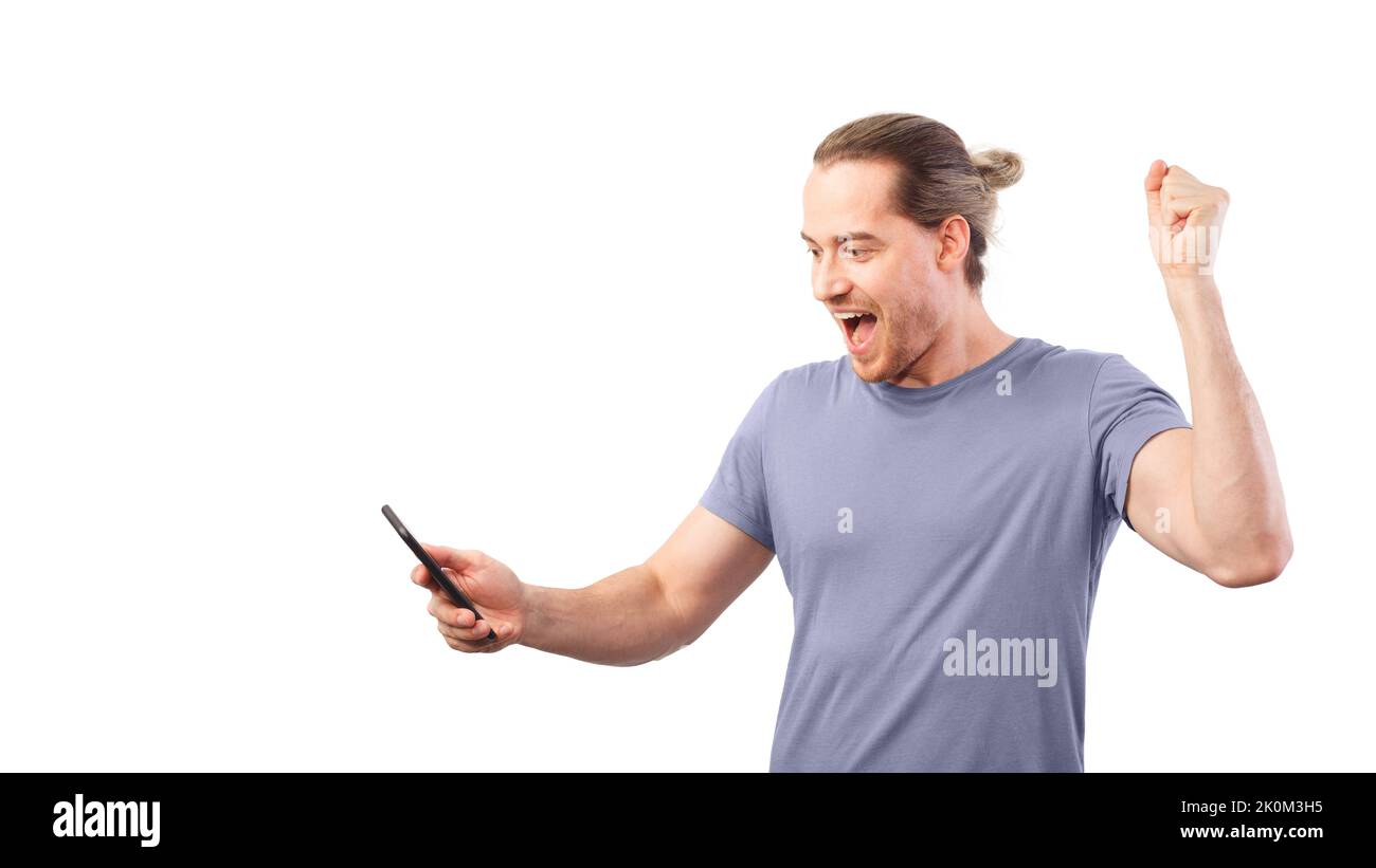 Concept of winning a lottery or a sweepstake. Man rejoices looking at his smartphone. Stock Photo