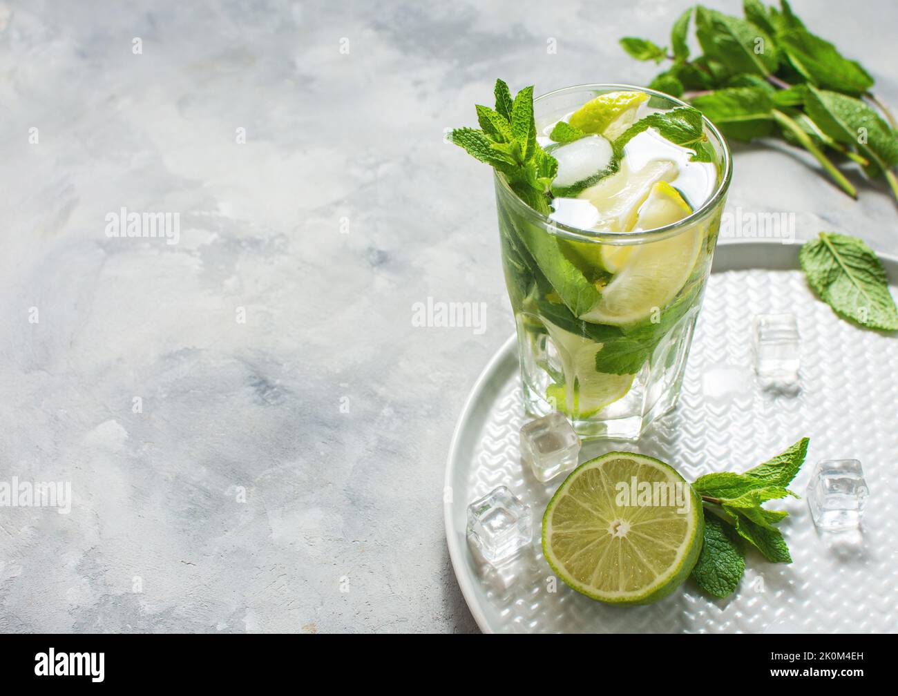 Refreshing summer alcoholic cocktail mojito with ice, fresh mint and lime. Copy space Stock Photo