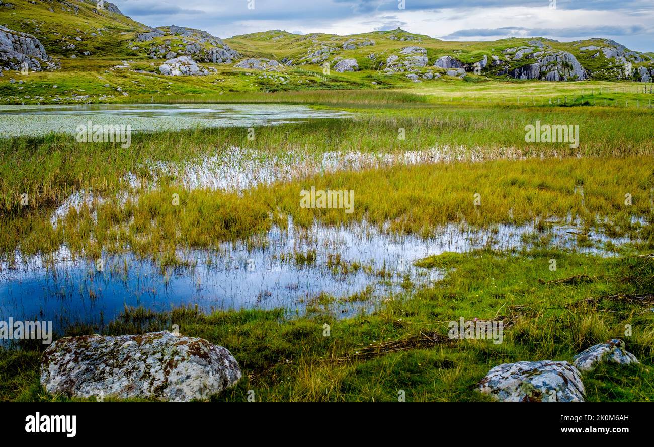 Ben Hogh (106 metres) is the highest hill on Coll with Loch Ballyhaugh in the foreground Stock Photo