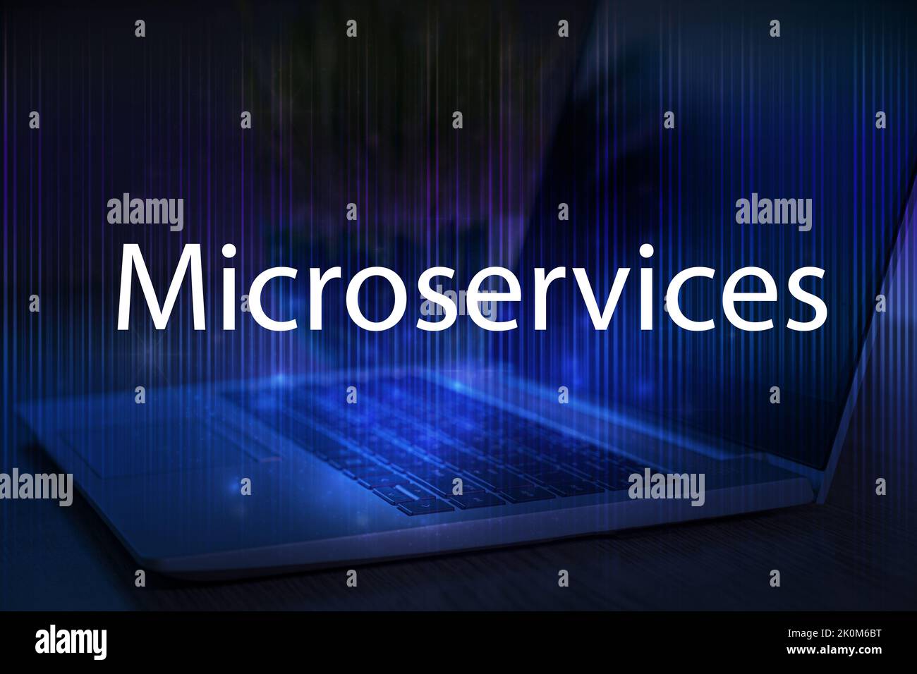 Microservices text on blue technology background with laptop. Stock Photo
