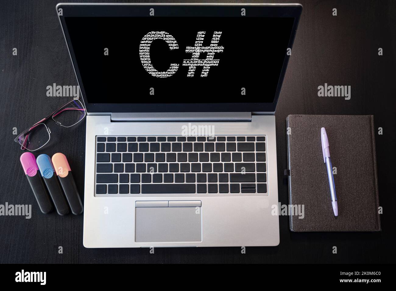 Laptop with C# text. Top view. C sharp inscription on laptop screen ...