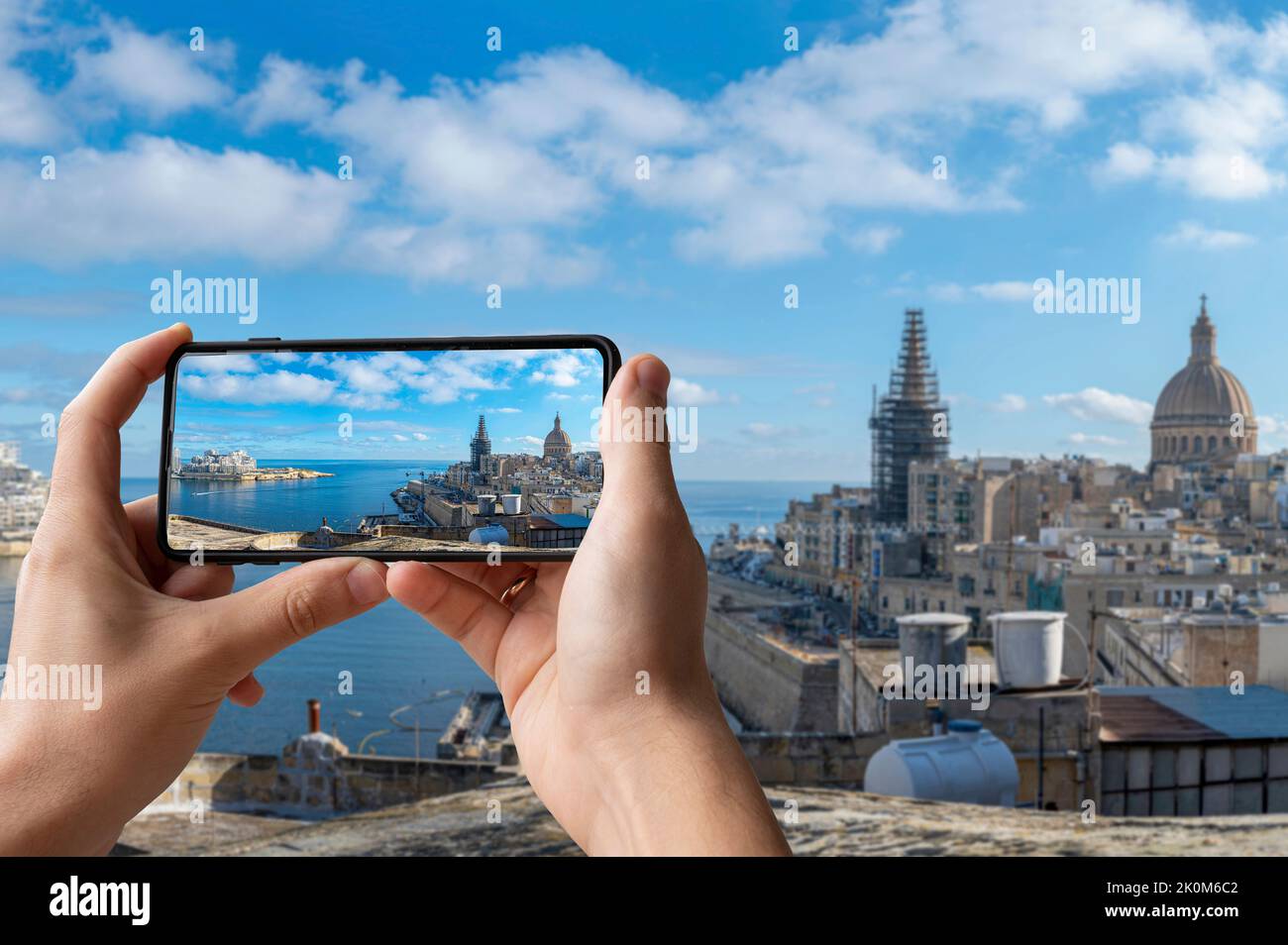 Tourist taking photo of Valletta harbor with Valletta old town and Sliema, Valletta, Malta. Stock Photo