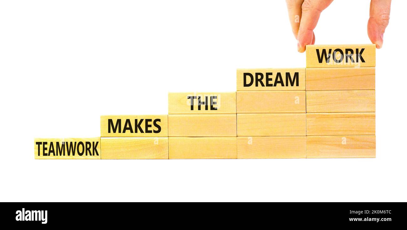 Teamwork makes dream work symbol. Concept words Teamwork makes the dream work on wooden blocks on beautiful white background. Businessman hand. Busine Stock Photo