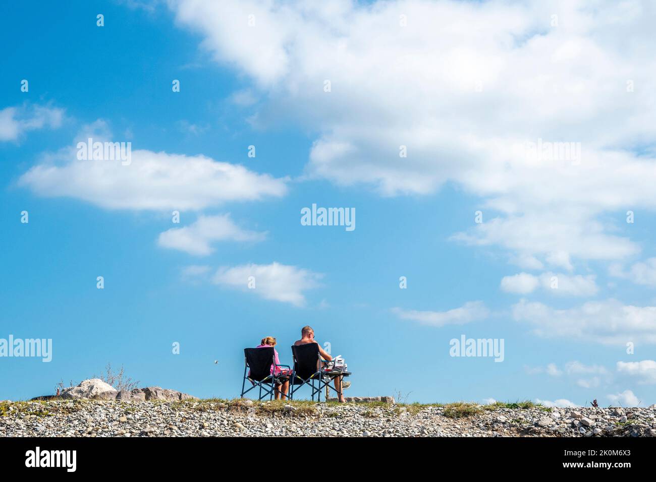 Wish You Were Here... Holidaymakers on West Shore beach at Llandudno on the coast of North Wales, UK. Stock Photo