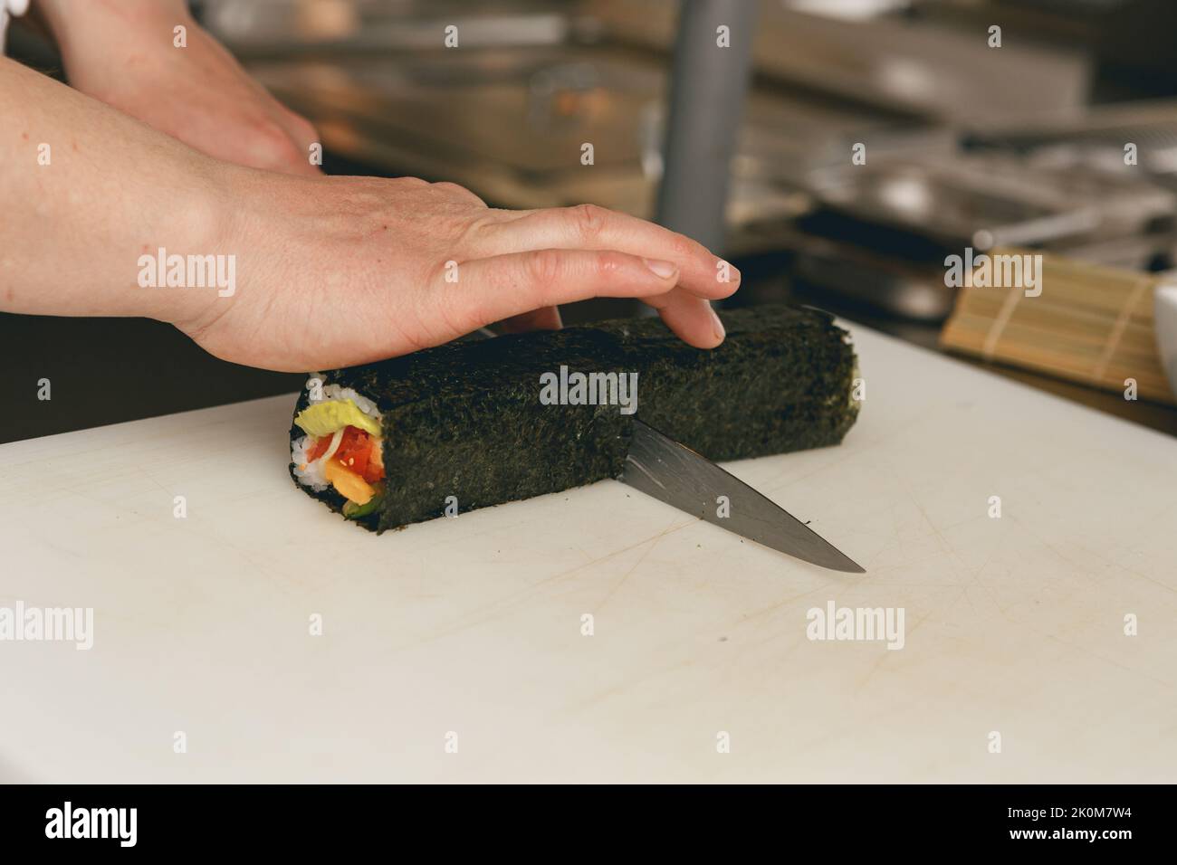 Close up of man japanese restaurant chef cooking sushi in the kitchen  Stock Photo