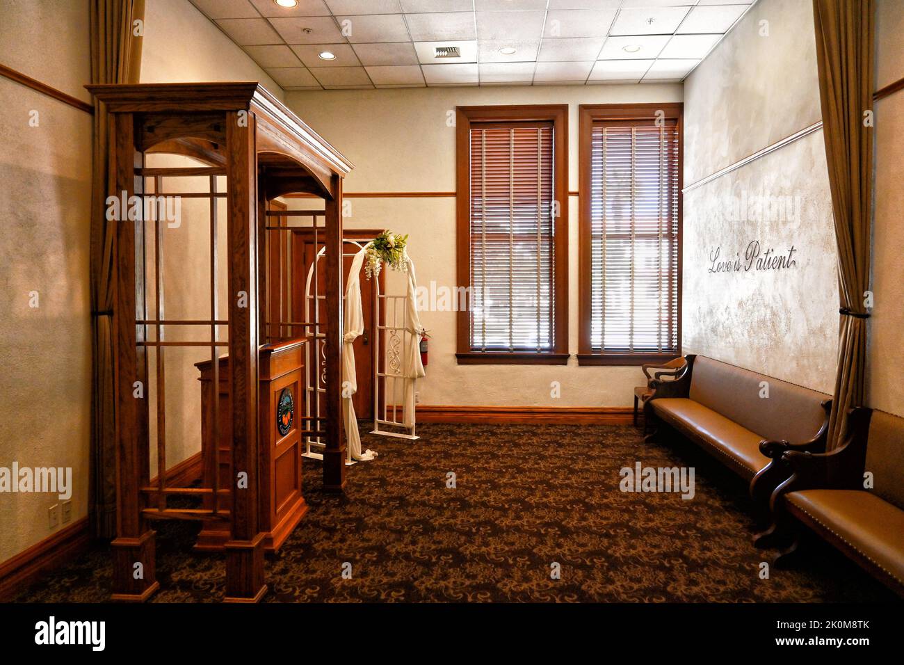 SANTA ANA, CALIFORNIA - 22 AUG 2022: One of the rooms where weddings are performed at the Old Orange County Courthouse, with Love is Patient written o Stock Photo