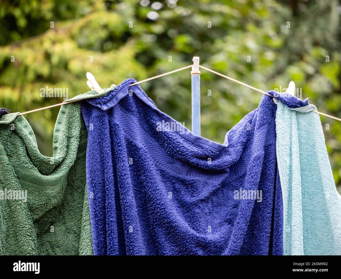 washing hanging on the washing line wet towels held with clothes pegs and clothes prop Stock
