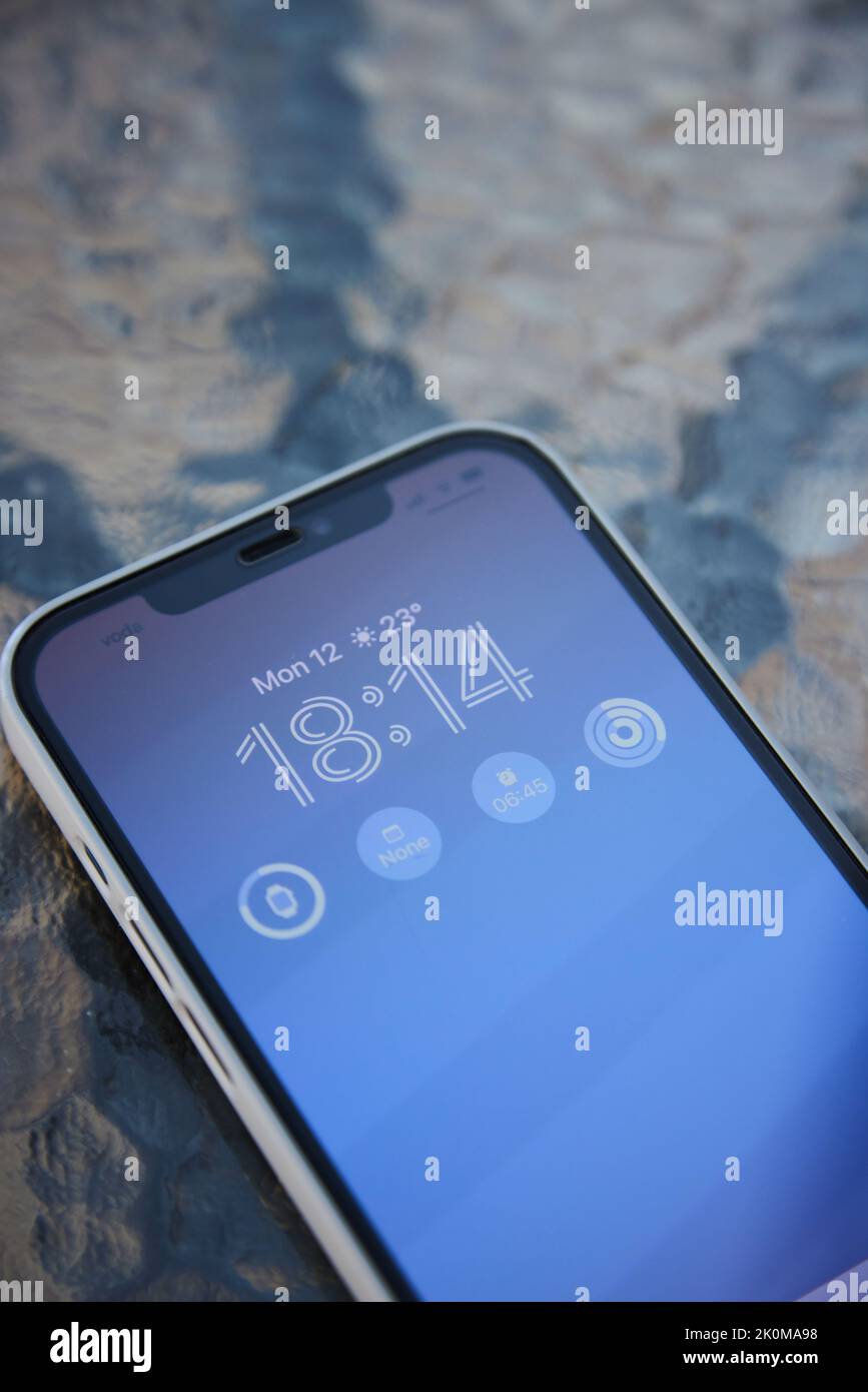 Close up of Apple iPhone 12 Pro Max with ios 16 new Clock design on Display Stock Photo Alamy