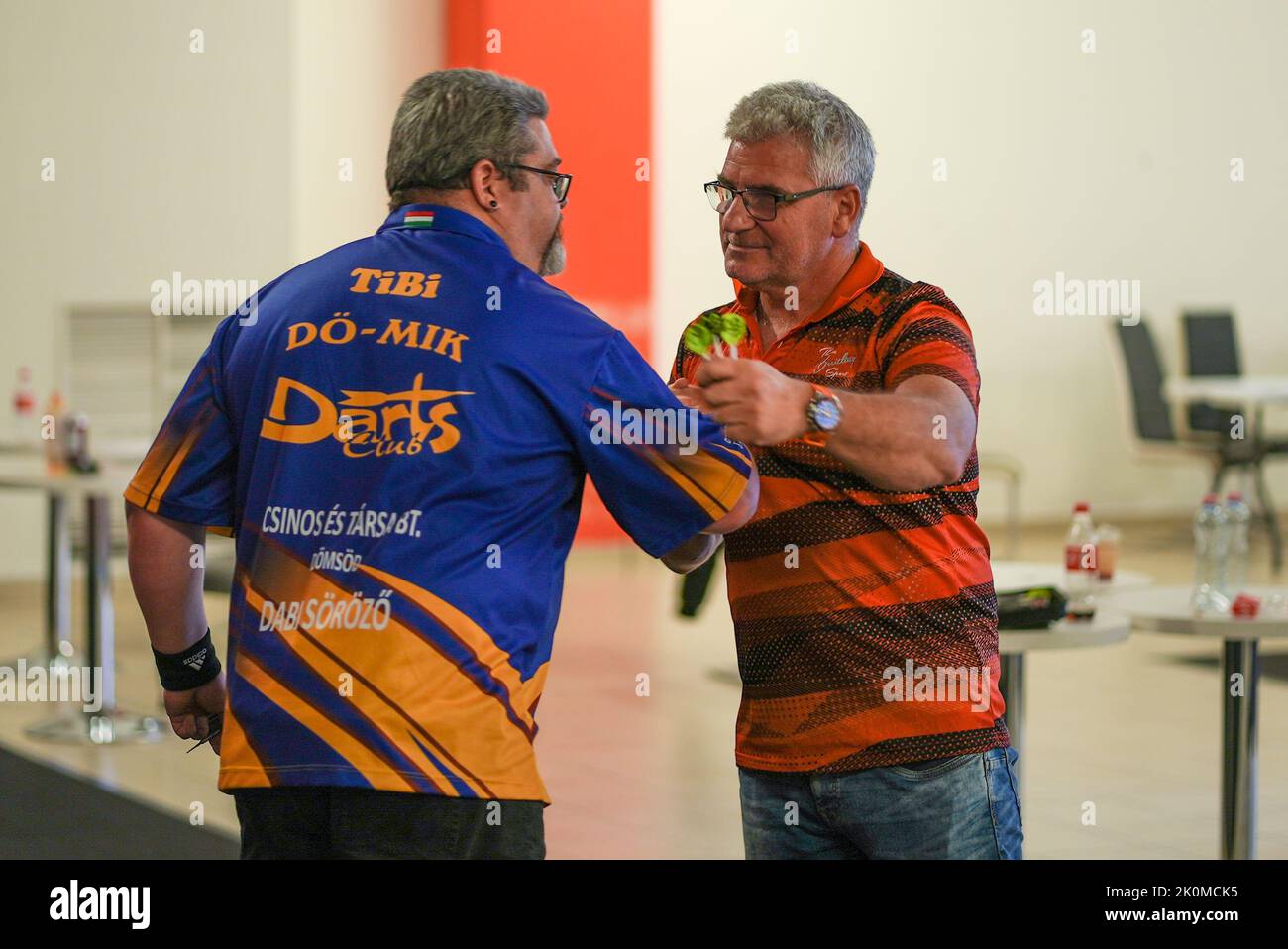 Two darts players congratulate each other after the match Stock Photo