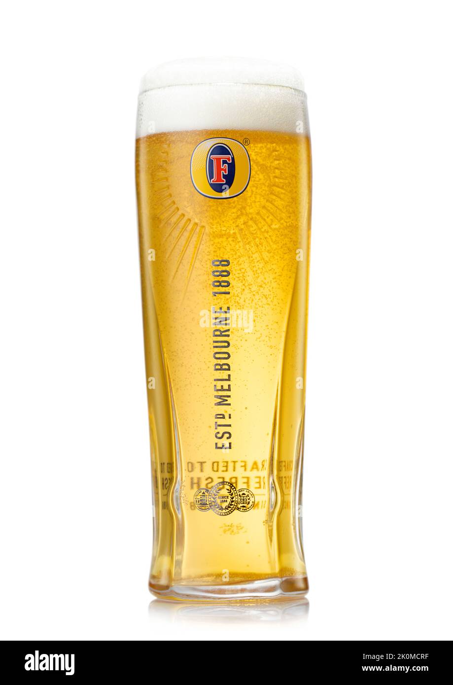 LONDON,UK - AUGUST 20,2022: Fosters lager beer in original glass on white. Stock Photo