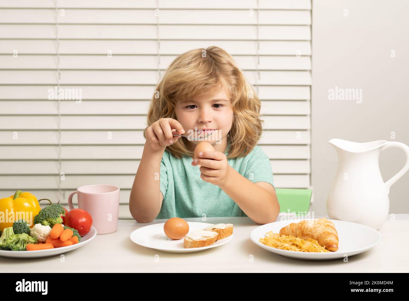 Child eating egg. Child boy eating organic healthy food. Healthy