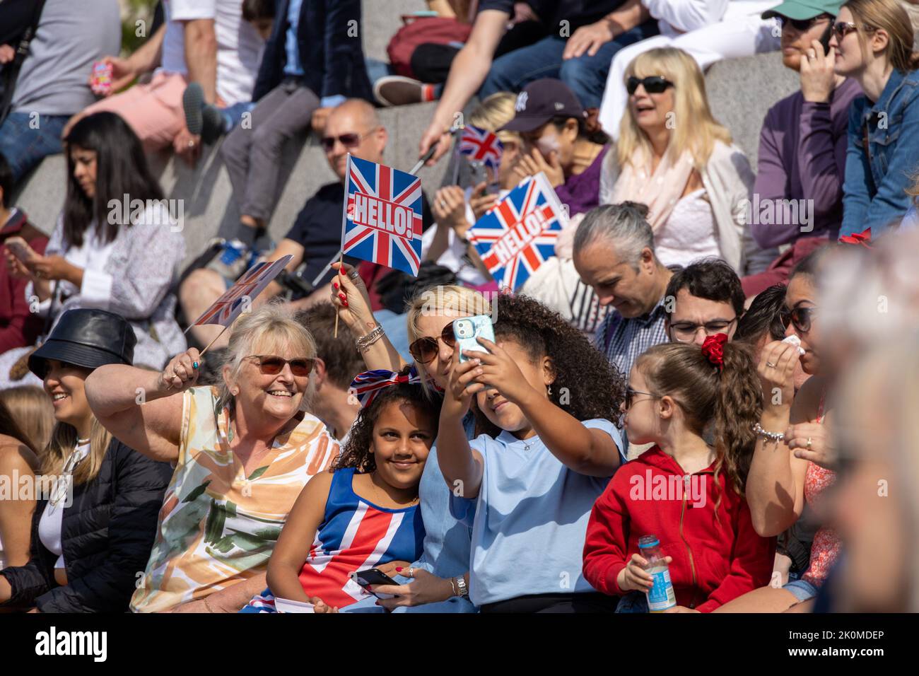 Group of people taking a selfie in the UK with Union Jack flags during the Platinum Jubilee in June 2022 Stock Photo