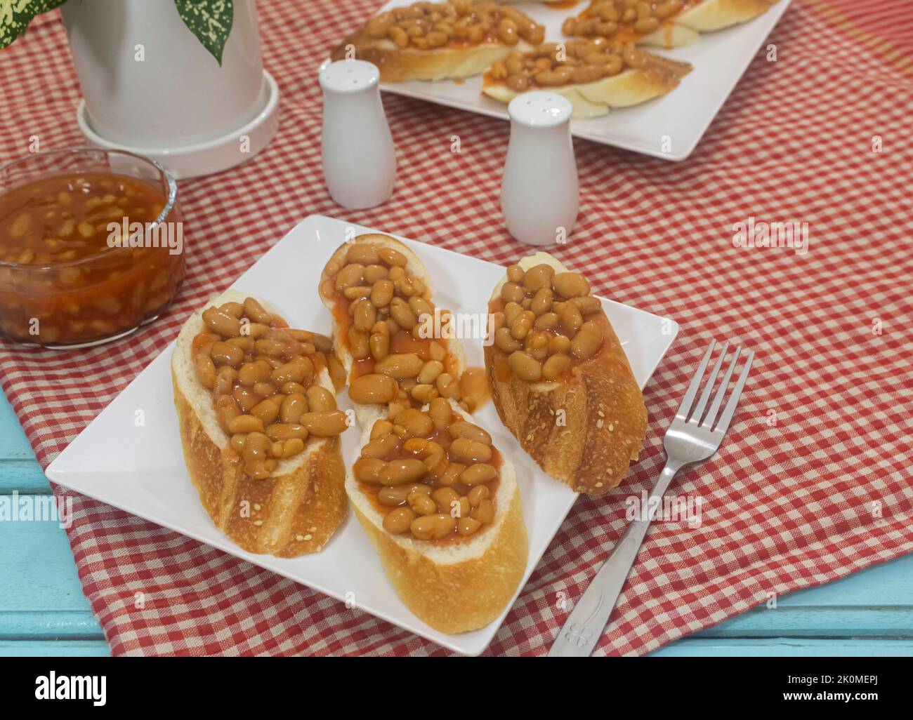 Homemade baked beans with French baguette. American and English cuisine