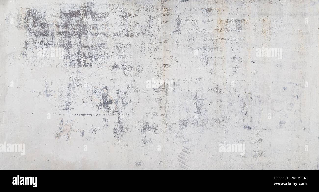 Front view of a weathered, aged & dirty wall, white plastered and painted surface peeling off. Abstract high resolution full frame textured background Stock Photo