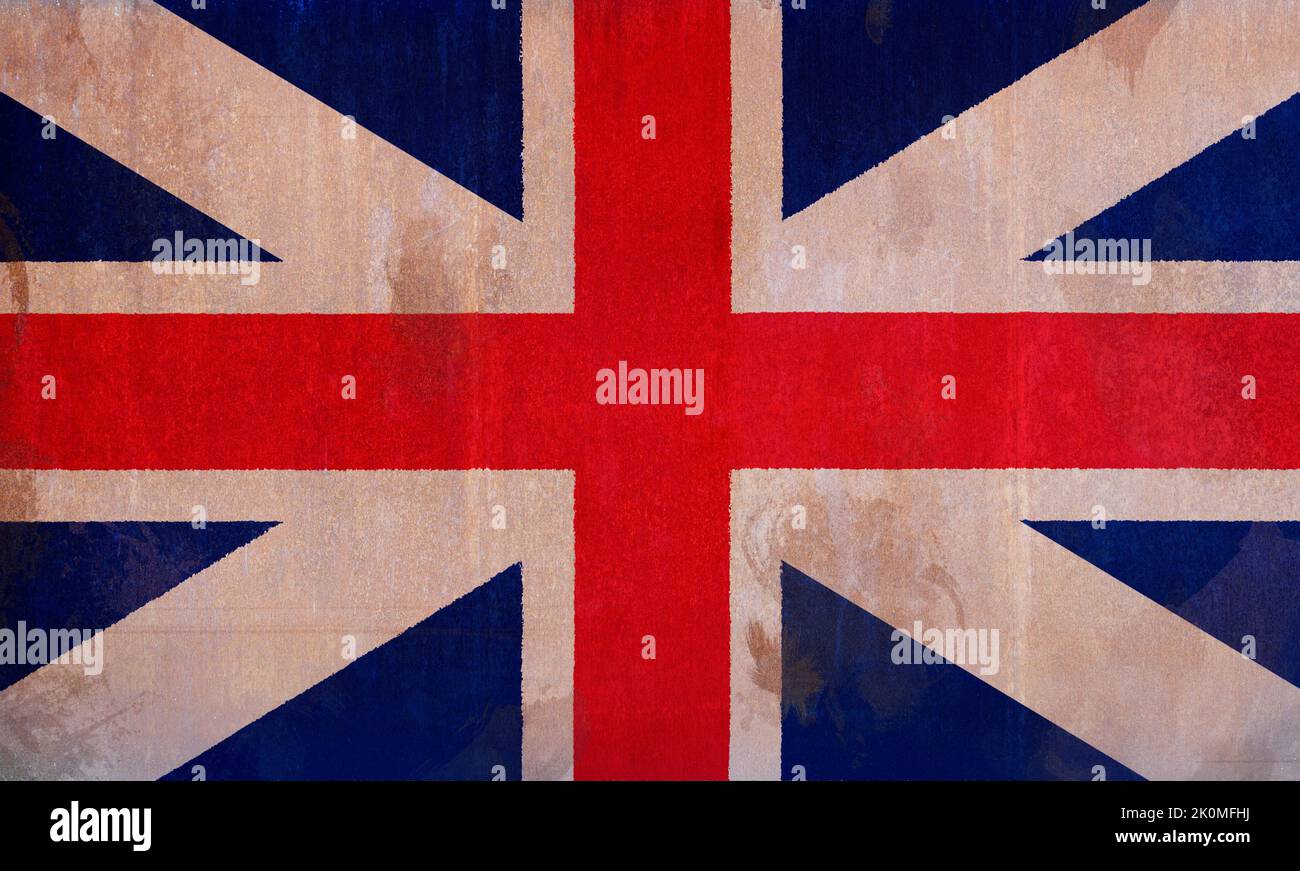 Full frame front view photo of a weathered British (United Kingdom, UK) flag (Union Jack) painted on a rusty, grunge and dirty wall. Stock Photo