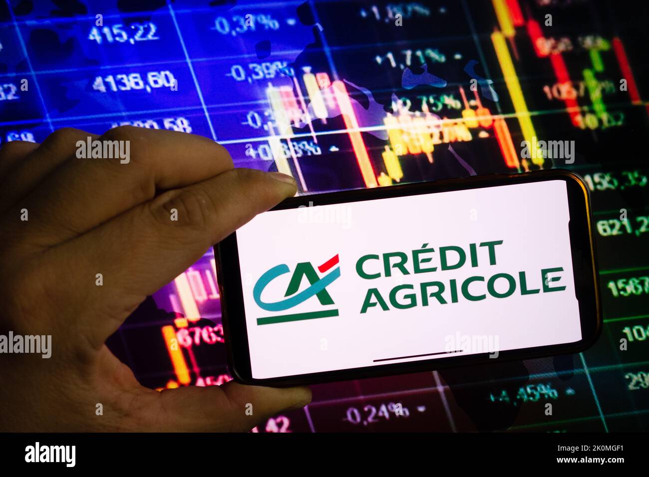 KONSKIE, POLAND - September 10, 2022: Smartphone displaying logo of Credit Agricole company on stock exchange diagram background Stock Photo
