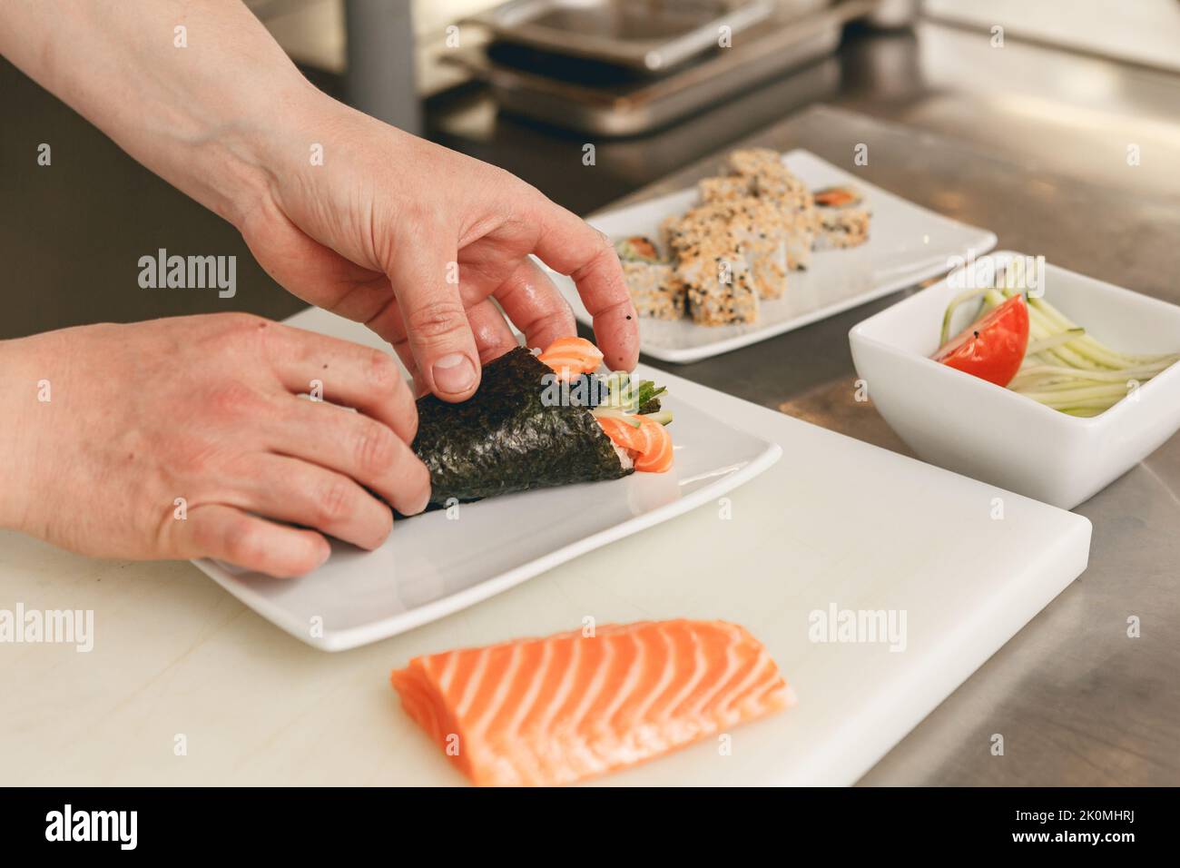 Close up of man japanese restaurant chef cooking sushi in the kitchen  Stock Photo