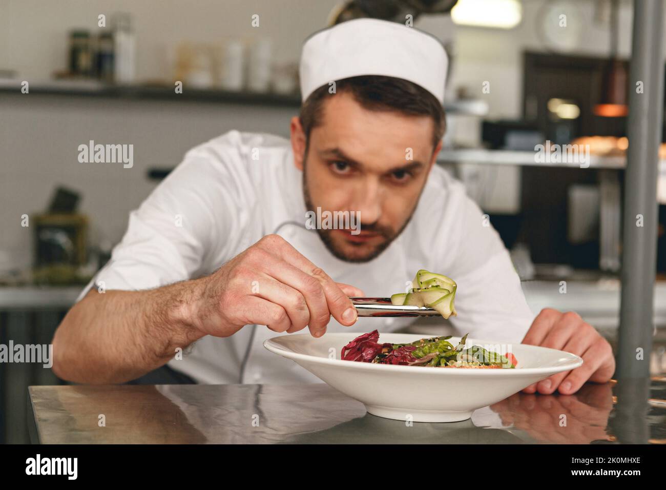 Chef preparing salad in the modern kitchen of restaurant. Tasty and healthy food Stock Photo