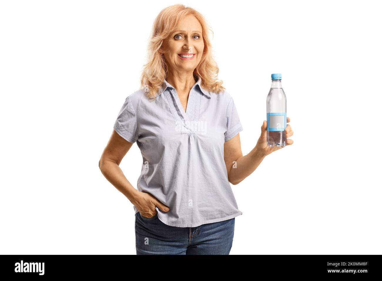 Woman holding a plastic bottle of water and smiling isolated on white ...