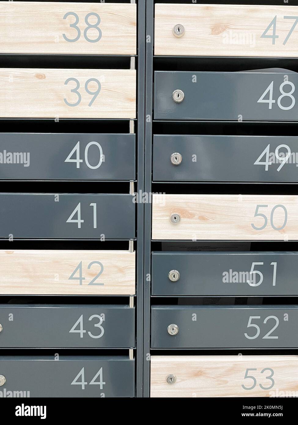 Even rows of numbered mailboxes. Metal mailboxes near the entrance in