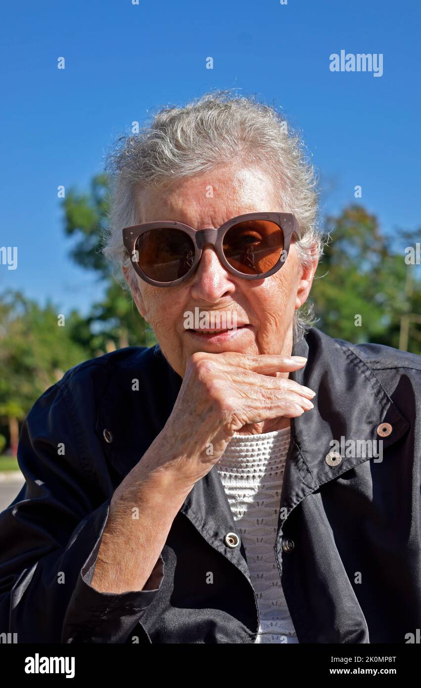 Elderly woman on sunglasses smiling Stock Photo Alamy