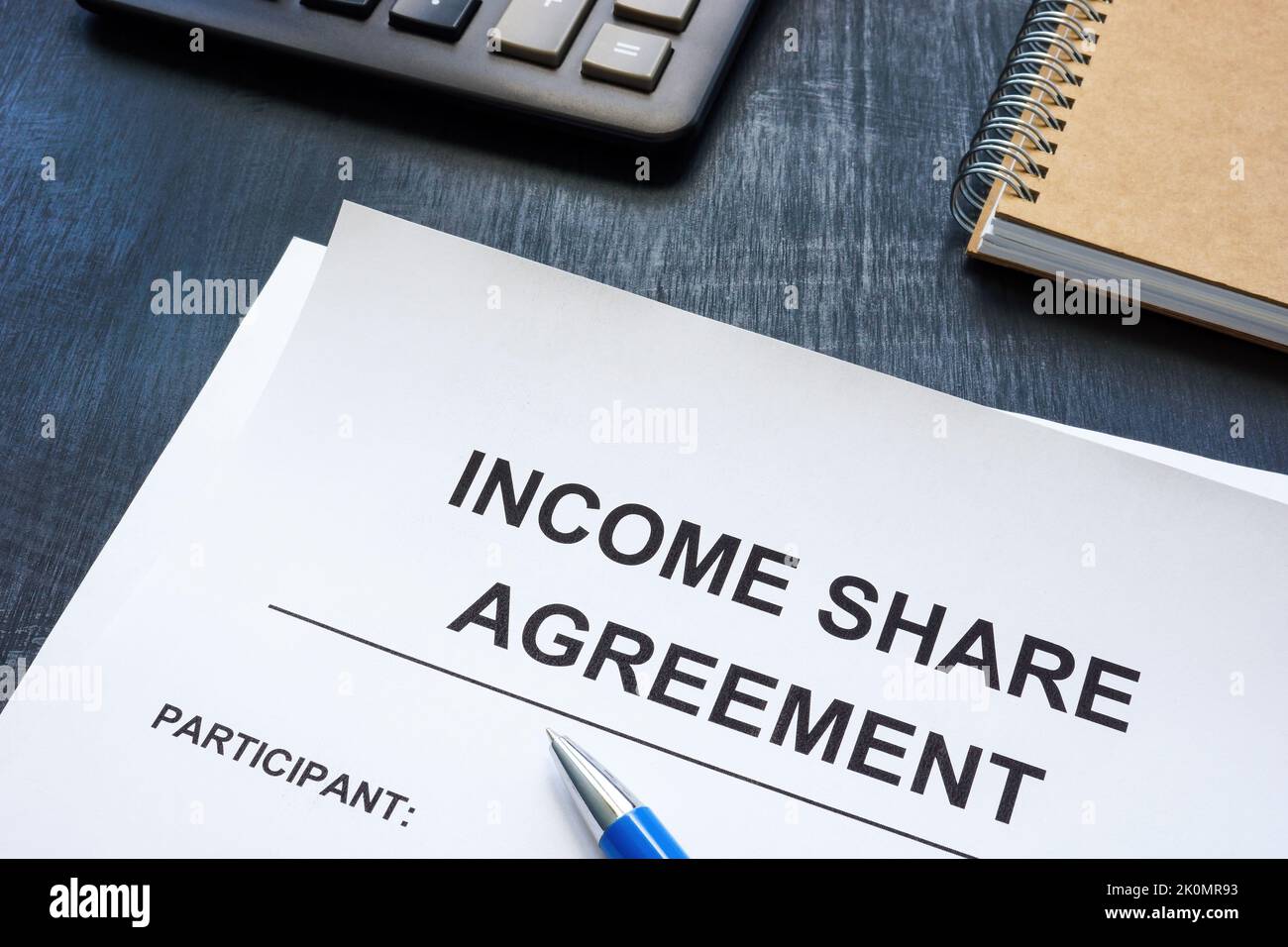 Income share agreement near notepad on the desk. Stock Photo