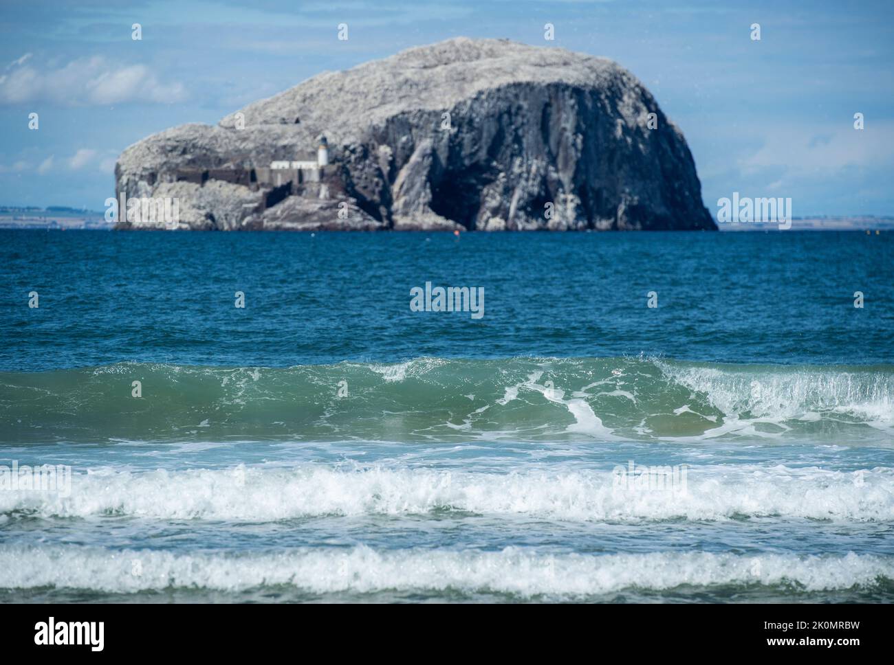 Waves approaching Seacliff Beach in North Berwick, East Lothian, Scotland, with Bass Rock in the background Stock Photo