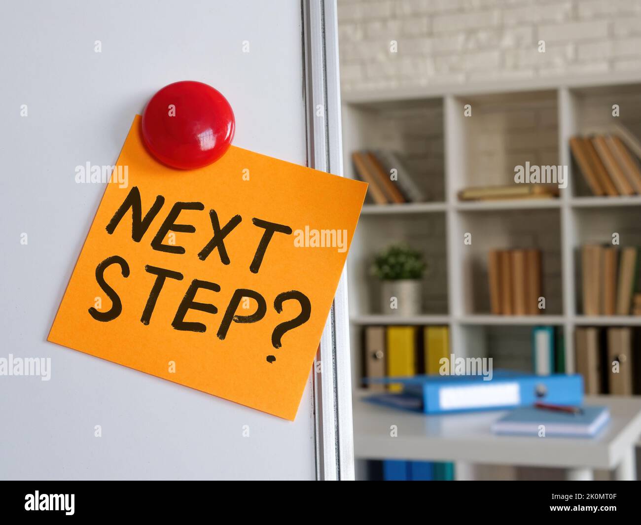 Sticker with phrase Next step on the whiteboard. Stock Photo