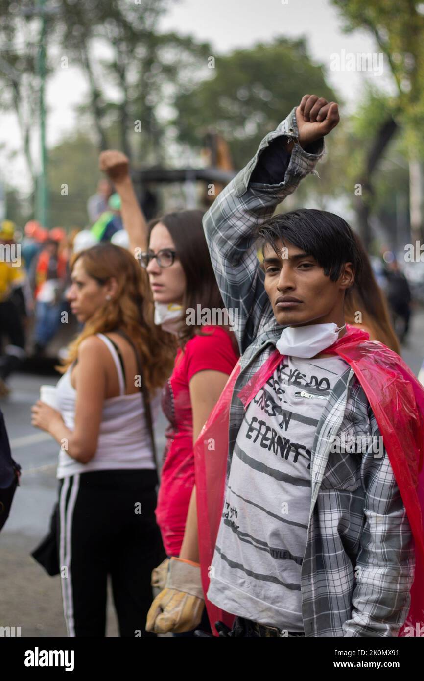 People doing the silence sign during rescue operations. In 2017, an 8.1 ...