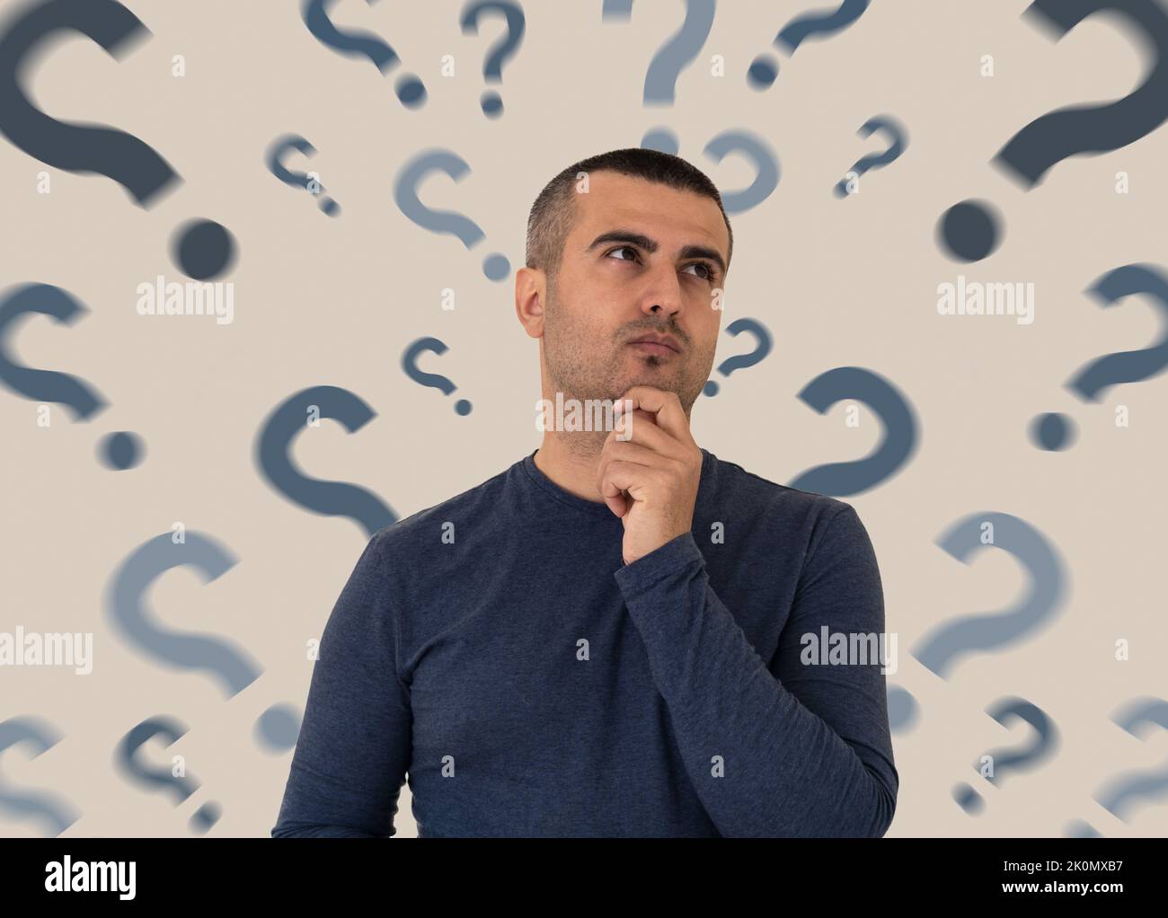 Close up photo of pensive and thoughtful man with the question marks on the backround. Concept of FAQ and mindblowing to find answer to questions. Stock Photo
