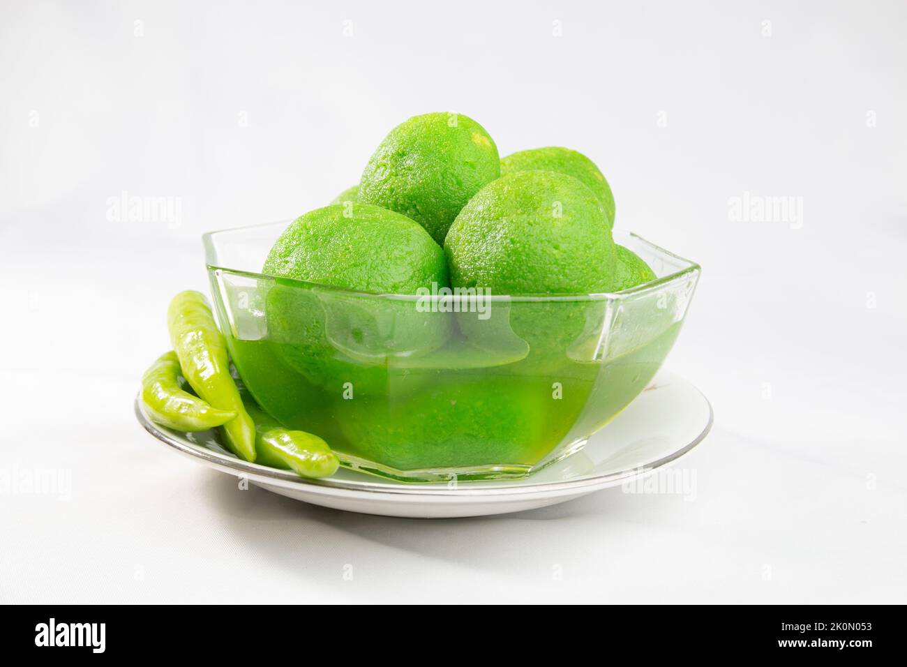 Chili sweets on bowl. green colored, chilli flavored, hot and sweet taste. unusual odd taste dessert. Stock Photo