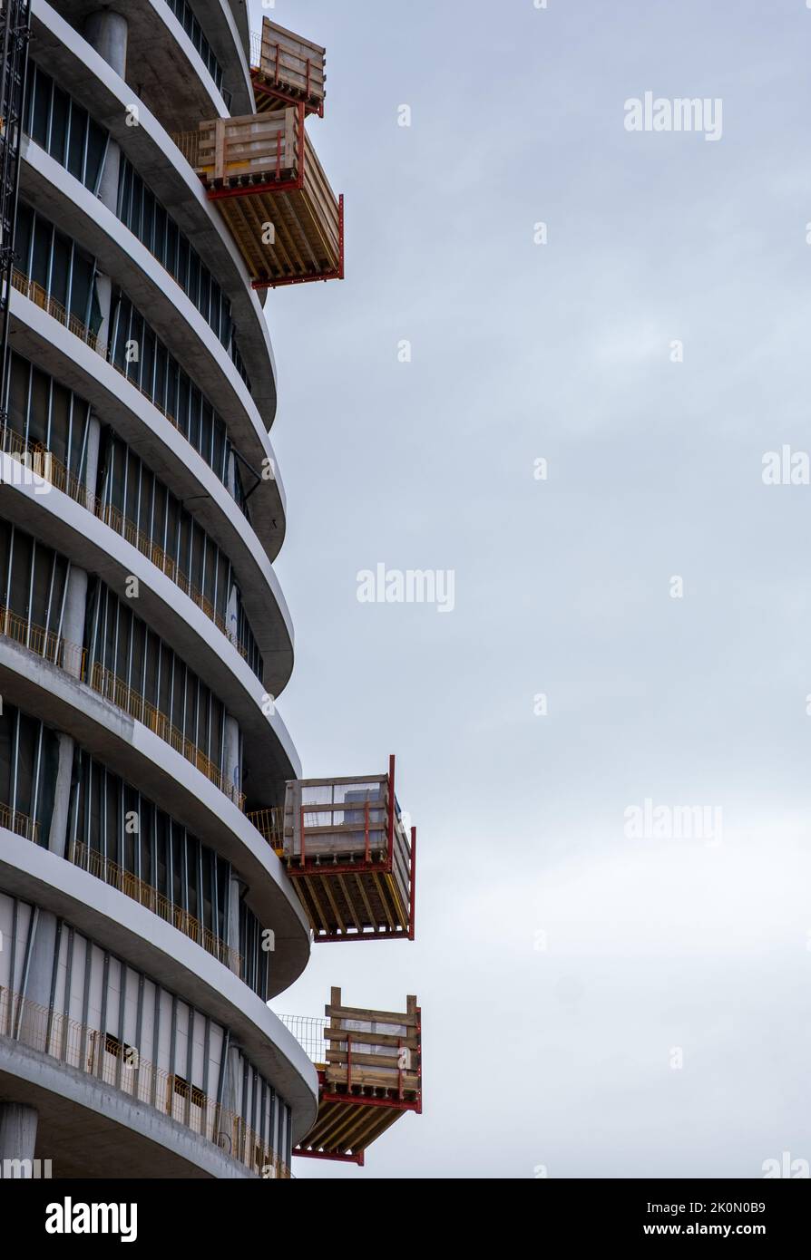 Construction of modern skyscraper building with luxury apartments against sky. Residential development. Stock Photo