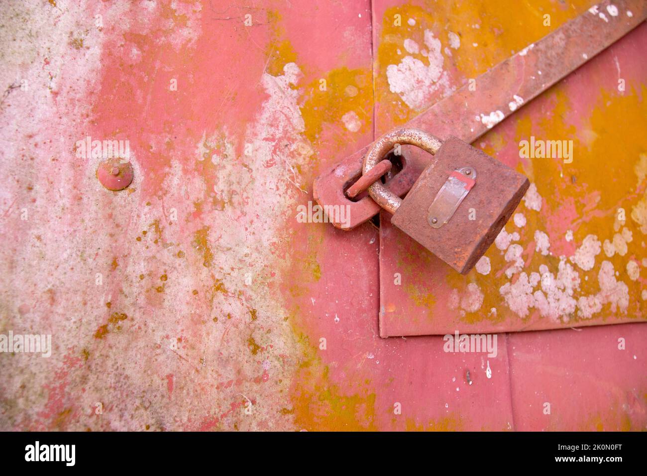 A old lock on a small door of a paddy container in tropical contrary. because of long stay it get rust and fungi on it. traditional paddy store room i Stock Photo