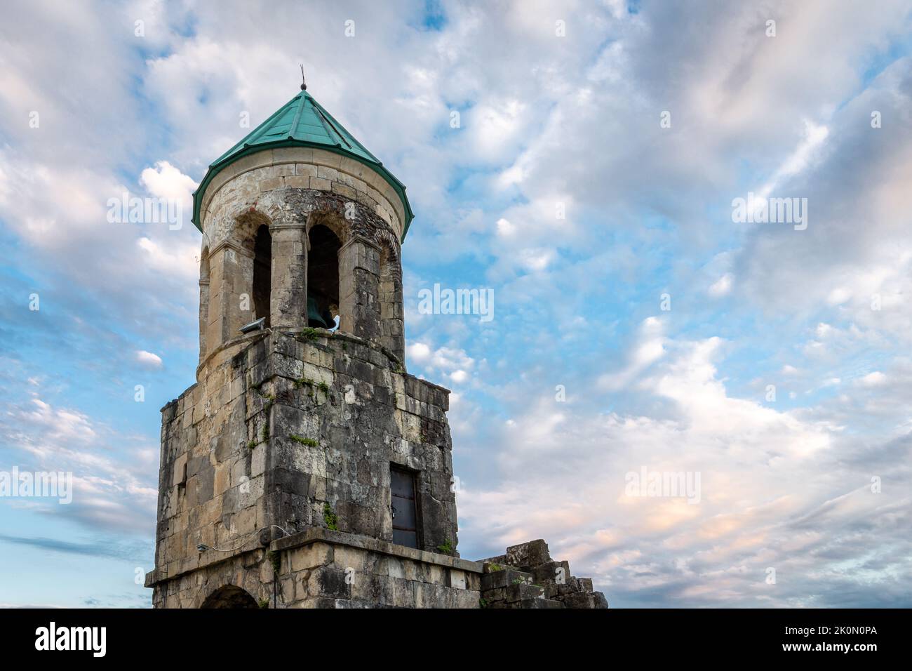 Belfry tower of Bagrati Cathedral (Kutaisi Cathedral), XI-century monastery, example of Georgian architecture with stone walls and turquoise dome agai Stock Photo